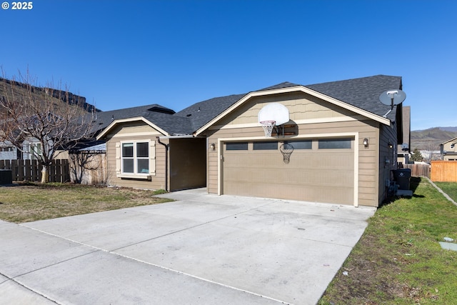 single story home featuring driveway, roof with shingles, an attached garage, fence, and a front lawn