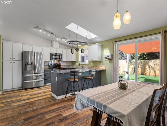 1908 NW 4th Ave, Battle Ground, WA 98604 - dining space with lofted ceiling, dark wood finished floors, and a skylight