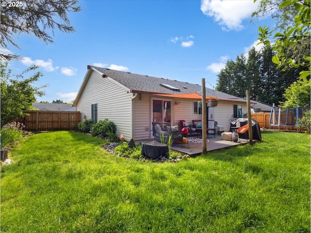 1908 NW 4th Ave, Battle Ground, WA 98604 - rear view of property featuring a trampoline, a wooden deck, and an outdoor hangout area