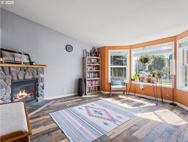 1908 NW 4th Ave, Battle Ground, WA 98604 - living area featuring a fireplace, baseboards, and wood finished floors