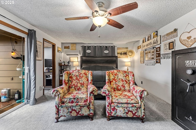 living area with ceiling fan, an AC wall unit, carpet floors, and a textured ceiling