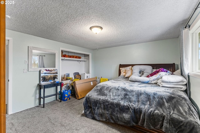 bedroom with carpet and a textured ceiling