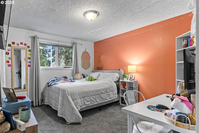 bedroom featuring a textured ceiling and carpet