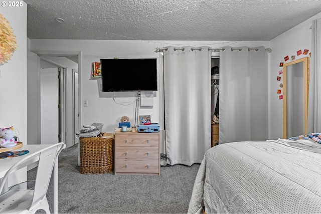 carpeted bedroom with a textured ceiling