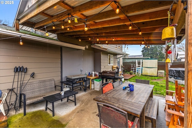 view of patio / terrace with a shed and a grill