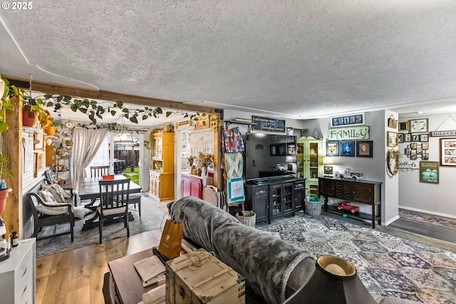 living room with wood-type flooring and a textured ceiling