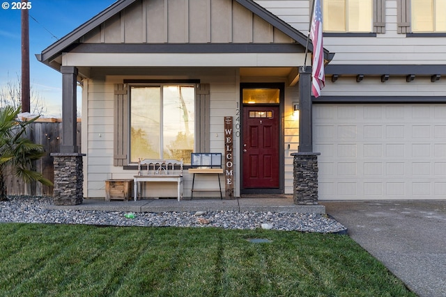 entrance to property featuring a porch and a garage