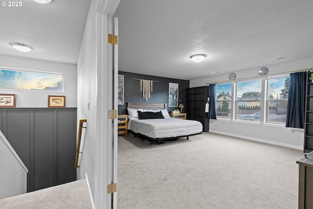 carpeted bedroom with a textured ceiling