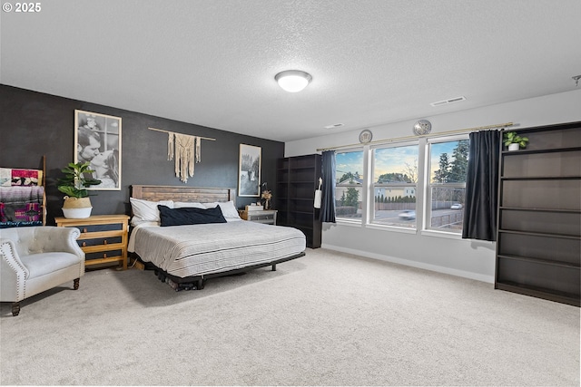 bedroom featuring carpet flooring and a textured ceiling