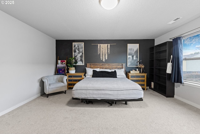 carpeted bedroom featuring a textured ceiling