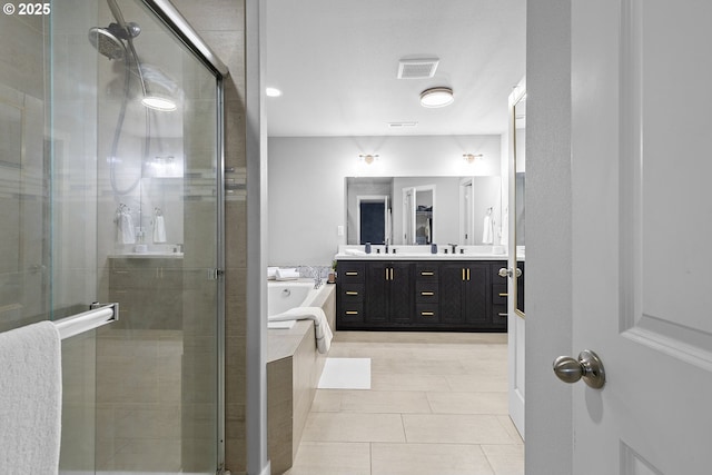 bathroom with tile patterned floors, vanity, and shower with separate bathtub