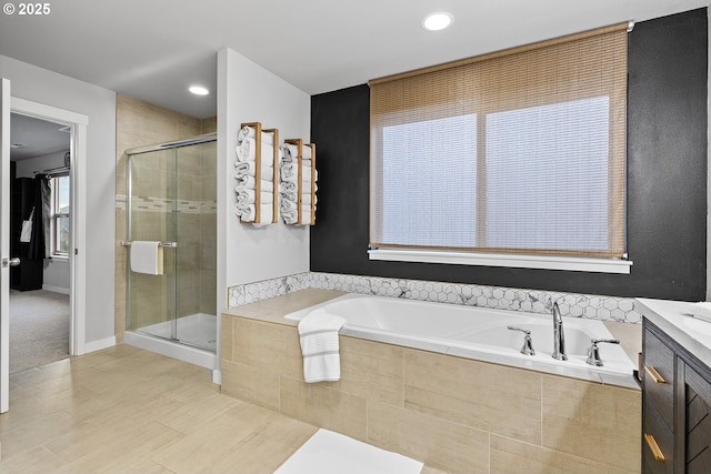 bathroom with vanity and separate shower and tub