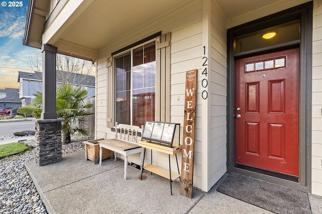 view of exterior entry with a porch