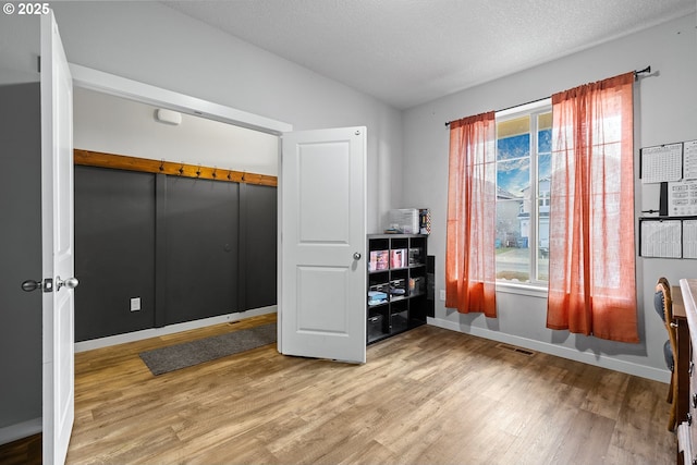 bedroom featuring a textured ceiling, hardwood / wood-style flooring, and a closet