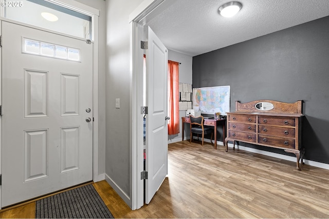 entryway featuring wood-type flooring and a textured ceiling