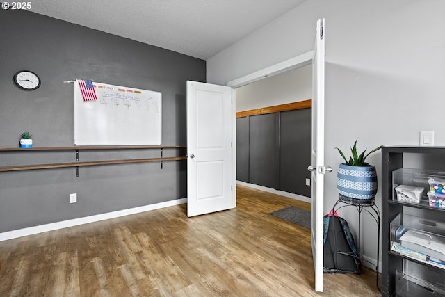 office space with a textured ceiling and hardwood / wood-style flooring