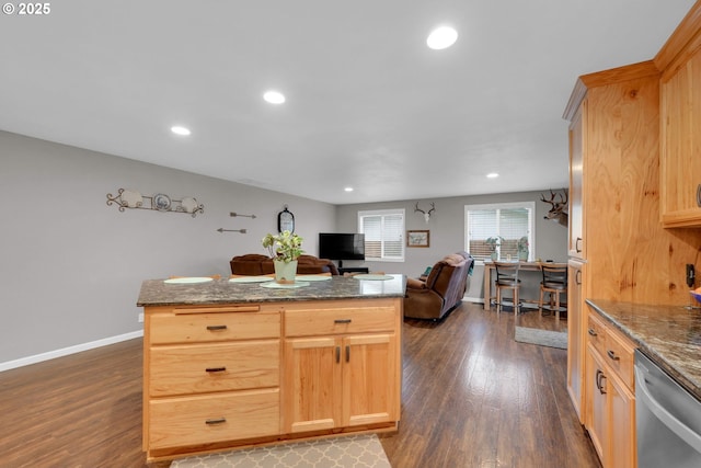 kitchen with baseboards, dark wood-type flooring, stainless steel dishwasher, and open floor plan