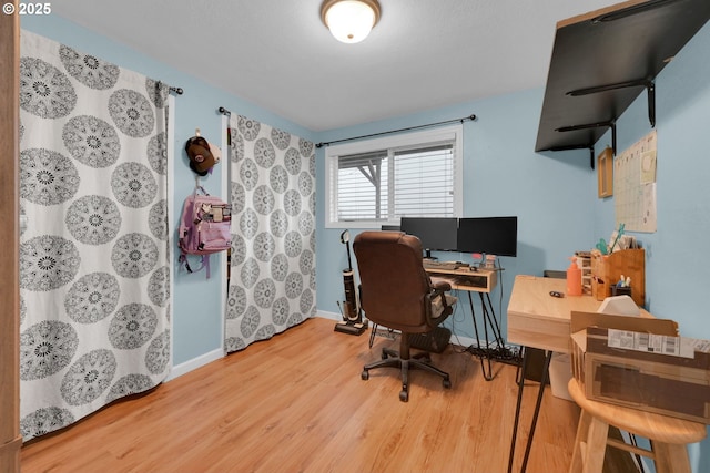 office space with baseboards and wood finished floors