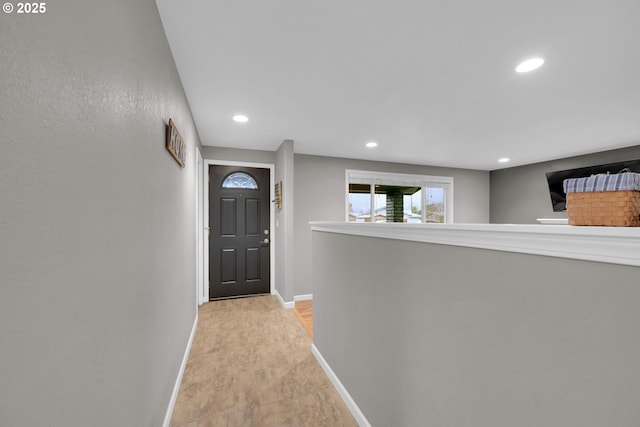 foyer with recessed lighting and baseboards