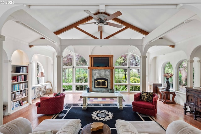 93652 E Blue Bird Ln, North Bend, OR 97459 - living area featuring a ceiling fan, healthy amount of natural light, beam ceiling, high vaulted ceiling, and a glass covered fireplace