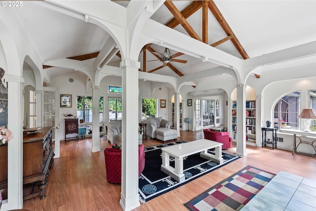 93652 E Blue Bird Ln, North Bend, OR 97459 - living room featuring ornate columns, beam ceiling, a ceiling fan, wood finished floors, and arched walkways