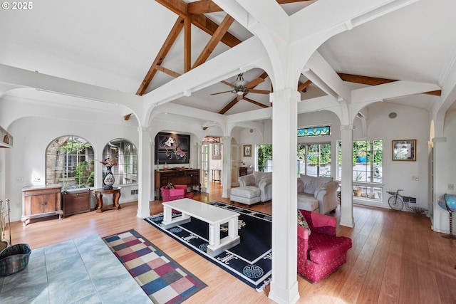 93652 E Blue Bird Ln, North Bend, OR 97459 - living room with ornate columns, beam ceiling, wood finished floors, arched walkways, and a ceiling fan