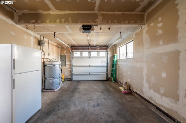 885 Ocean Dr SW, Bandon, OR 97411 - garage with freestanding refrigerator, electric panel, and a garage door opener