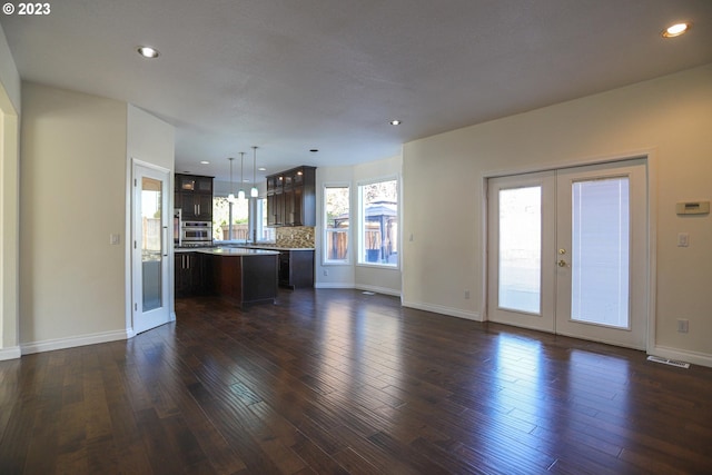 unfurnished living room featuring visible vents, baseboards, dark wood finished floors, french doors, and recessed lighting