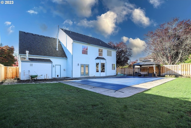 rear view of house with a patio area, a fenced backyard, a yard, and a gazebo