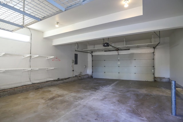 garage with a garage door opener and electric panel