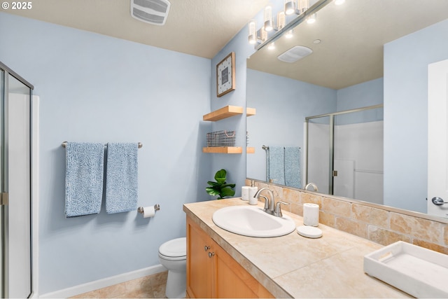 bathroom featuring visible vents, baseboards, toilet, vanity, and a shower stall