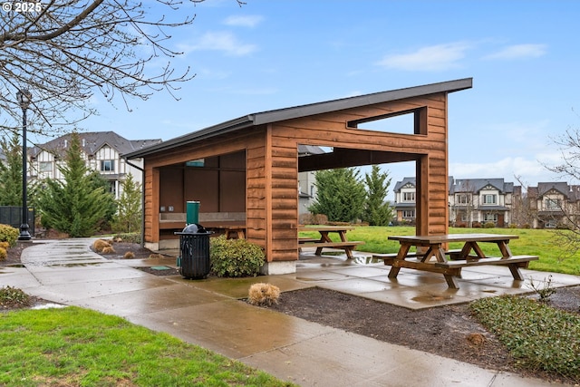 view of property's community with a residential view and a lawn