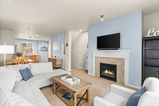 living area featuring recessed lighting, baseboards, light colored carpet, and a tiled fireplace