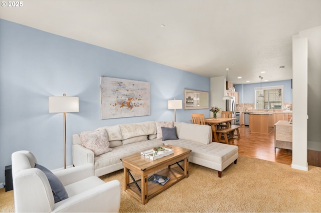 living room featuring light wood-type flooring and recessed lighting