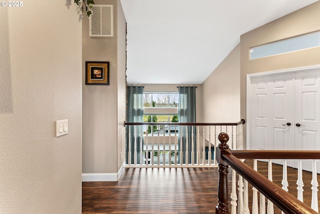 656 Ironwood Ter, Woodburn, OR 97071 - corridor featuring visible vents, wood finished floors, lofted ceiling, a textured wall, and baseboards