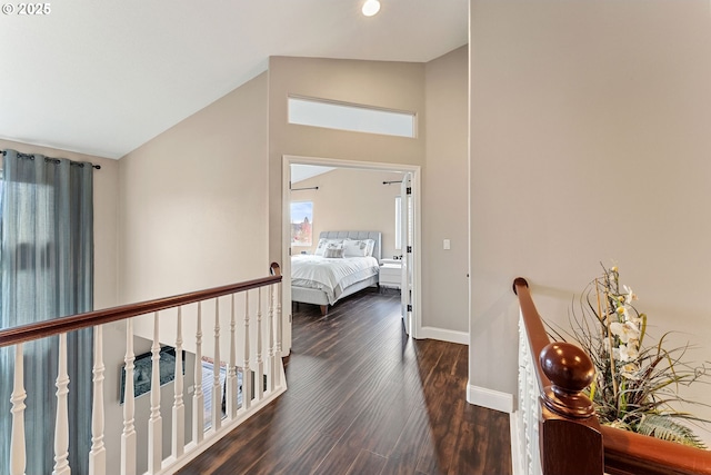 656 Ironwood Ter, Woodburn, OR 97071 - corridor featuring high vaulted ceiling, an upstairs landing, dark wood-style floors, and baseboards