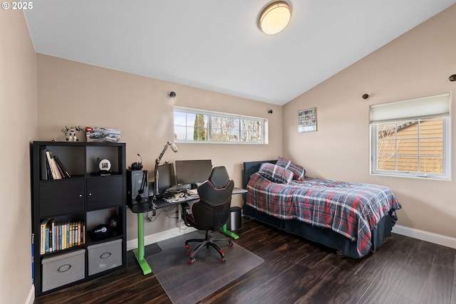 bedroom with dark wood-type flooring and lofted ceiling