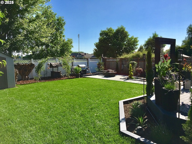 656 Ironwood Ter, Woodburn, OR 97071 - view of yard featuring a fenced backyard, a fire pit, and a patio