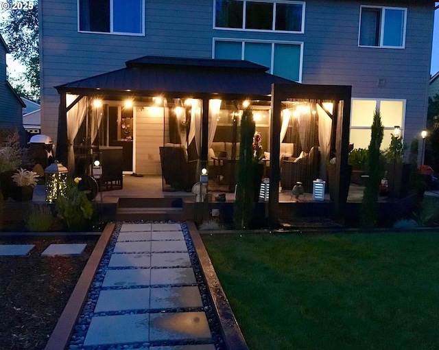 rear view of house with a yard and a patio area