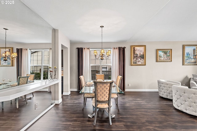 dining area with dark wood-type flooring and a chandelier