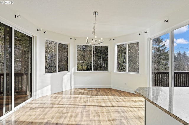 unfurnished sunroom with a chandelier