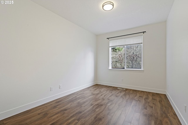 unfurnished room with wood-type flooring