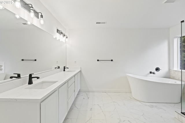 bathroom with vanity and a tub to relax in