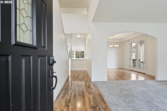 entrance foyer featuring a notable chandelier, hardwood / wood-style flooring, and a healthy amount of sunlight