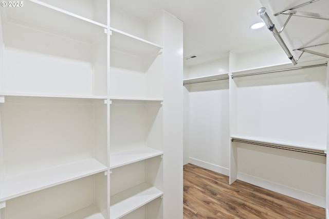 spacious closet featuring hardwood / wood-style flooring