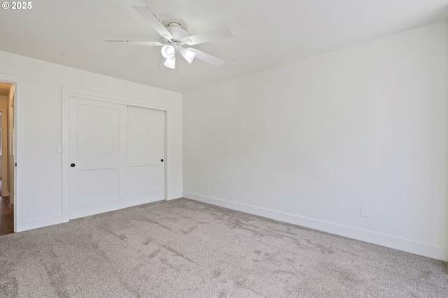 unfurnished bedroom featuring a closet, ceiling fan, and carpet flooring