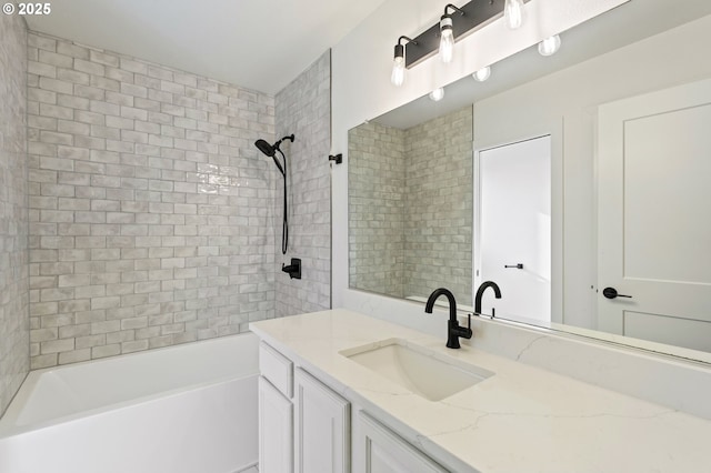 bathroom featuring vanity and tiled shower / bath combo