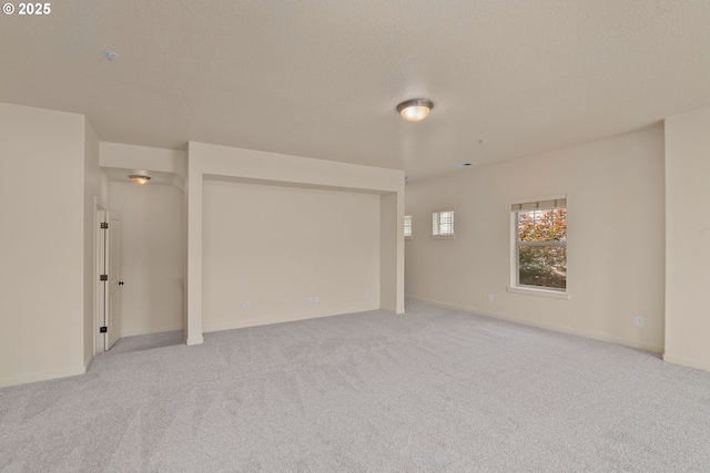 608 NE Adwick Dr, Beaverton, OR 97006 - spare room featuring light colored carpet, a textured ceiling, and a pendent fire sprinkler