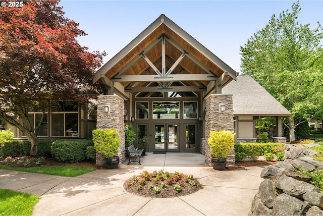 608 NE Adwick Dr, Beaverton, OR 97006 - property entrance with stone siding, french doors, and roof with shingles