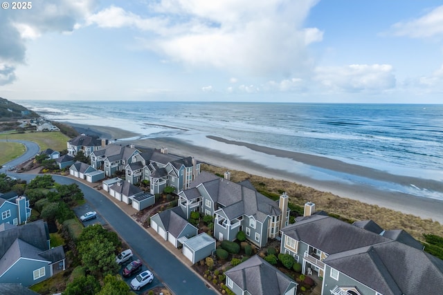 birds eye view of property featuring a view of the beach and a water view